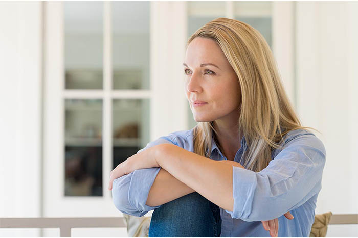 senior relaxing outdoors A woman looking content
